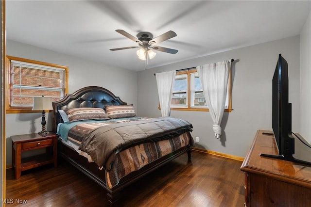 bedroom with dark hardwood / wood-style floors and ceiling fan