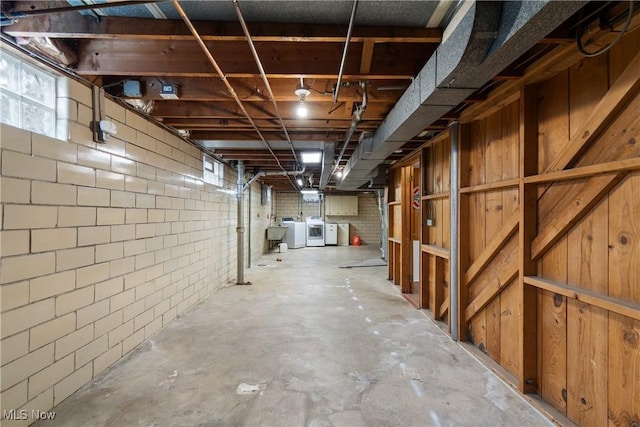 basement featuring washing machine and dryer and sink