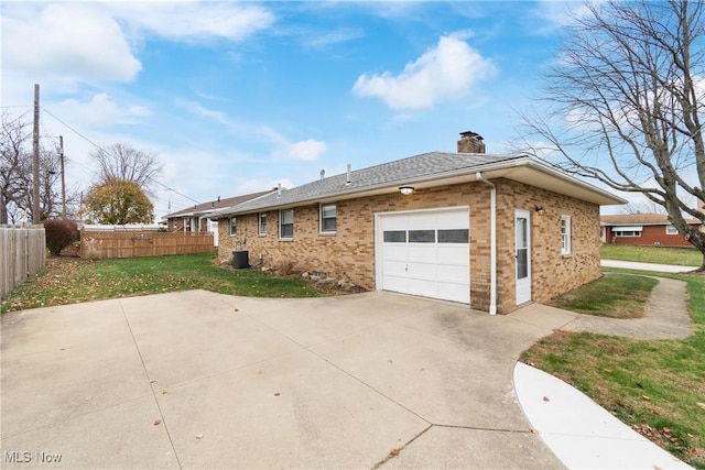 view of property exterior featuring a garage and a yard