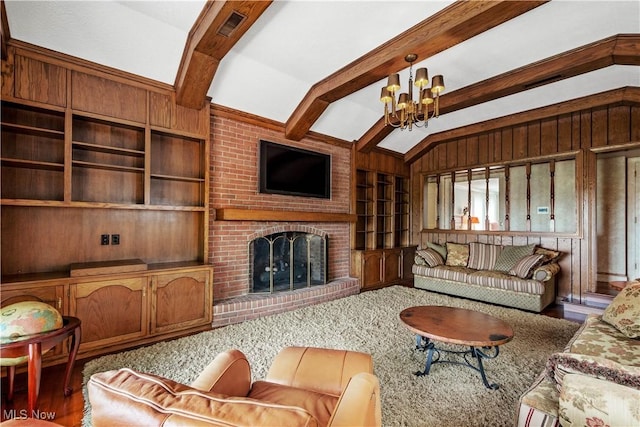 living room with an inviting chandelier, lofted ceiling with beams, wooden walls, hardwood / wood-style flooring, and a fireplace