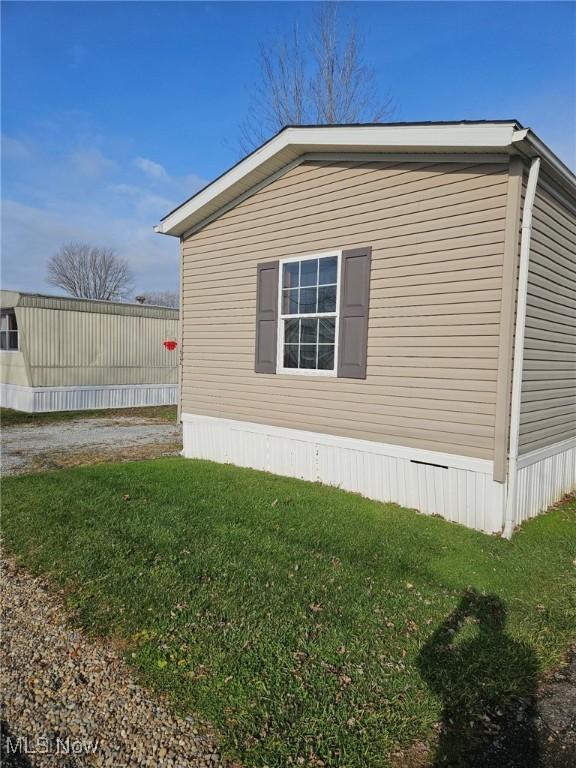 view of home's exterior with a yard