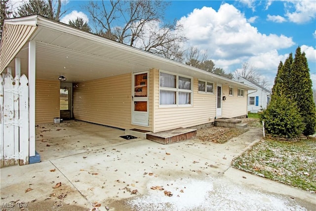 view of front of property featuring a carport