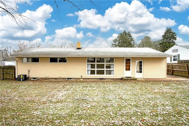 rear view of house featuring central AC