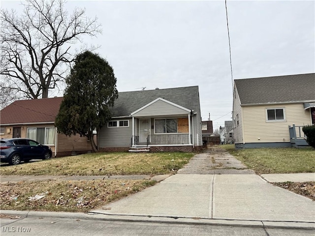 view of front of property with a porch and a front yard