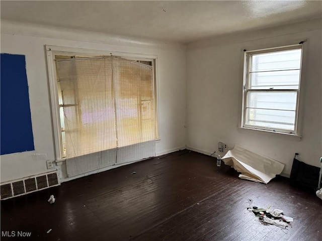 unfurnished room with dark hardwood / wood-style floors