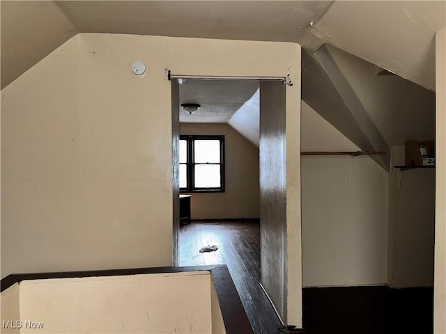 additional living space featuring dark hardwood / wood-style floors and vaulted ceiling