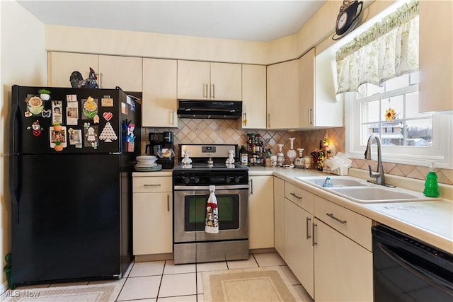 kitchen featuring cream cabinets, sink, backsplash, and black appliances