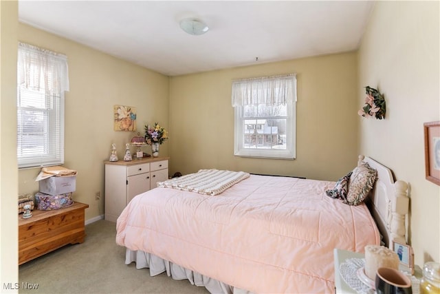 bedroom featuring light carpet