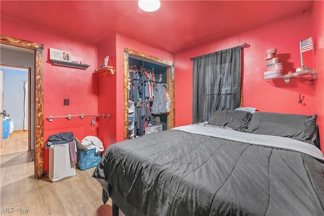 bedroom featuring hardwood / wood-style floors and a closet