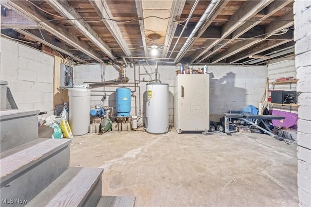 basement with gas water heater and white fridge