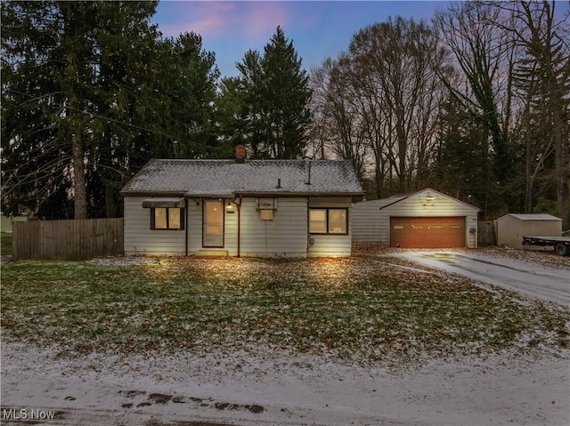 ranch-style home featuring an outbuilding and a garage