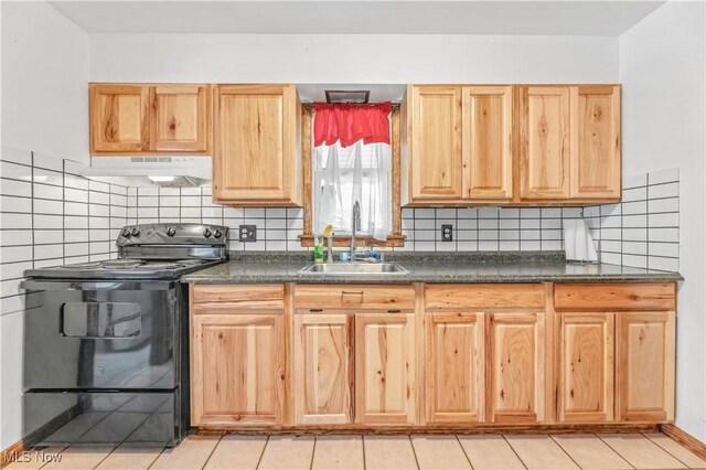 kitchen featuring light tile patterned floors, black range with electric cooktop, backsplash, and sink