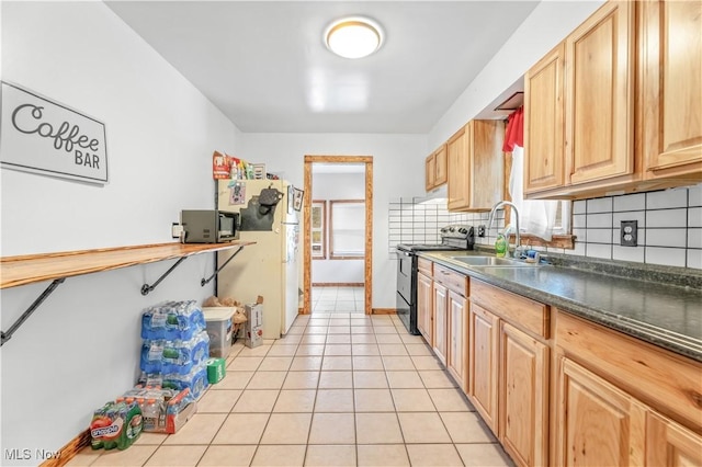 kitchen featuring backsplash, white fridge, sink, and black / electric stove