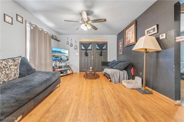 living room with hardwood / wood-style floors and ceiling fan