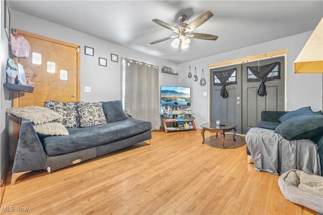 living room with ceiling fan and hardwood / wood-style floors