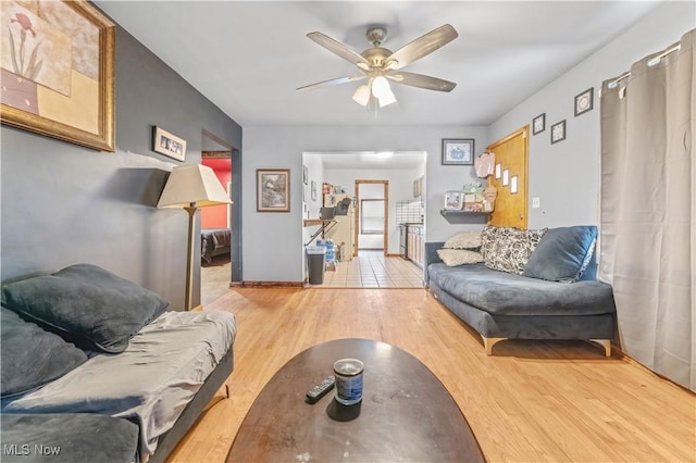 living room featuring ceiling fan and light wood-type flooring