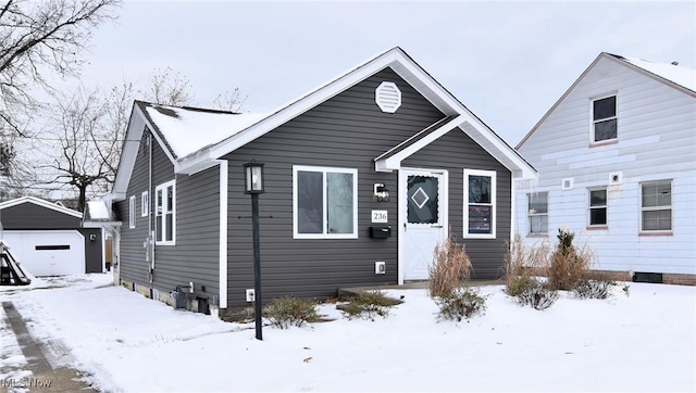 bungalow featuring an outdoor structure and a garage