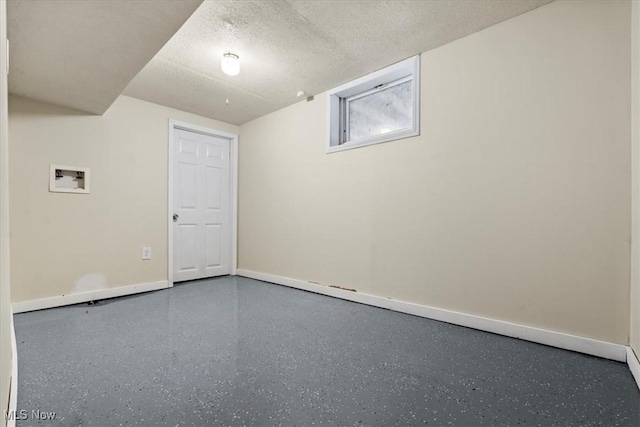 basement featuring a textured ceiling