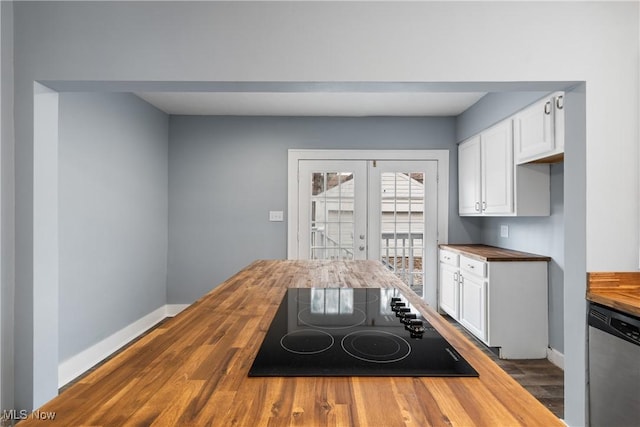 kitchen with butcher block counters, dishwasher, black electric stovetop, and white cabinets