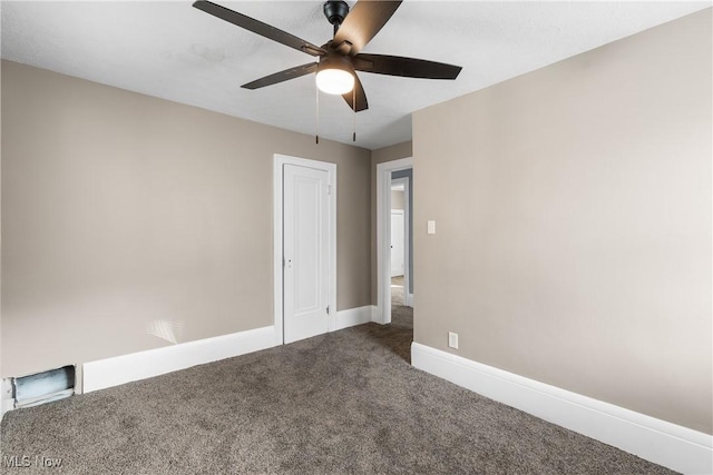 carpeted spare room with ceiling fan