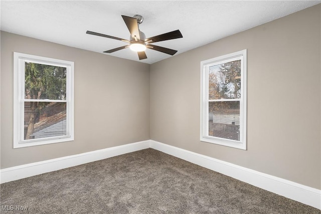 empty room featuring carpet floors, a wealth of natural light, and ceiling fan