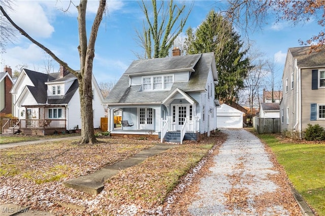 view of front of house featuring a garage and an outdoor structure