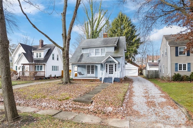 view of front of house with an outbuilding, a garage, and covered porch