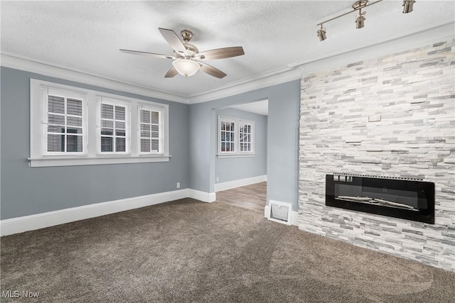 unfurnished living room with crown molding, a large fireplace, carpet, and a textured ceiling