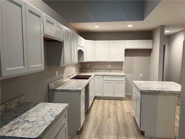 kitchen featuring white cabinets and light hardwood / wood-style flooring