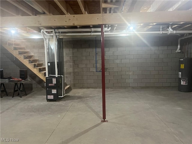 basement featuring heating unit and water heater