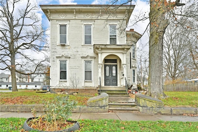 italianate home with fence