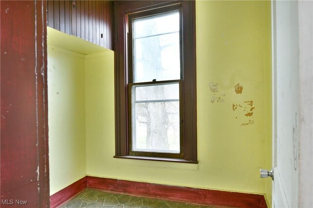 spare room featuring baseboards