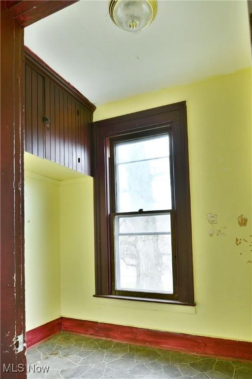 spare room featuring baseboards