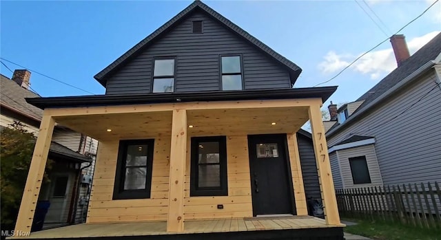 rear view of house featuring a porch