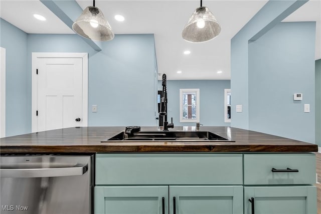 kitchen featuring a sink, wood counters, stainless steel dishwasher, and recessed lighting