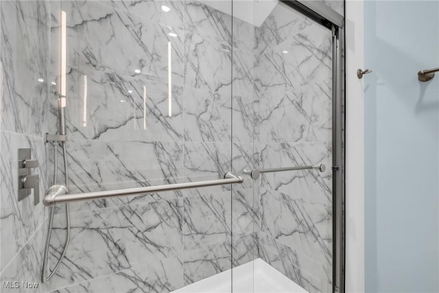 full bath featuring a marble finish shower