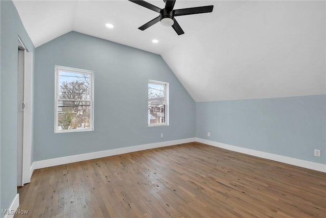 additional living space featuring baseboards, lofted ceiling, ceiling fan, wood finished floors, and recessed lighting