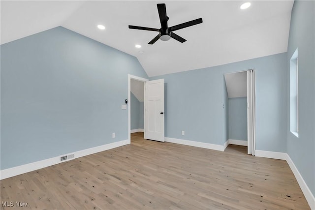 additional living space with lofted ceiling, visible vents, a ceiling fan, wood finished floors, and baseboards