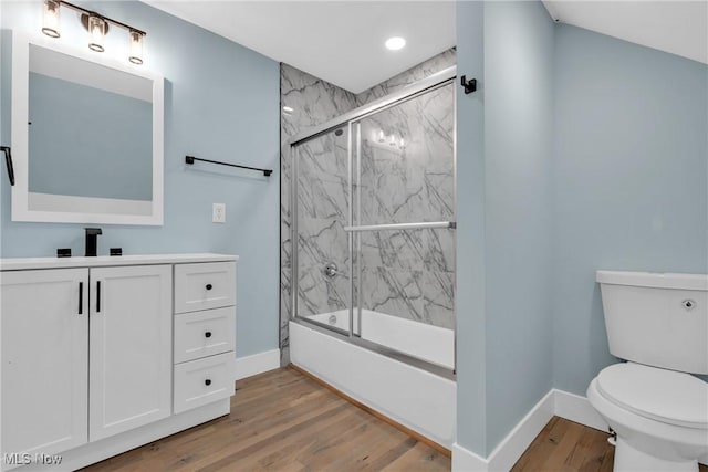 full bathroom with shower / bath combination with glass door, wood finished floors, toilet, and baseboards