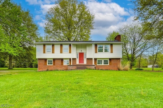 split foyer home with a front lawn