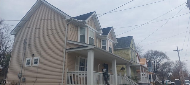 view of side of home with a porch