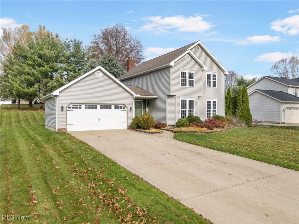 front of property with a front yard and a garage