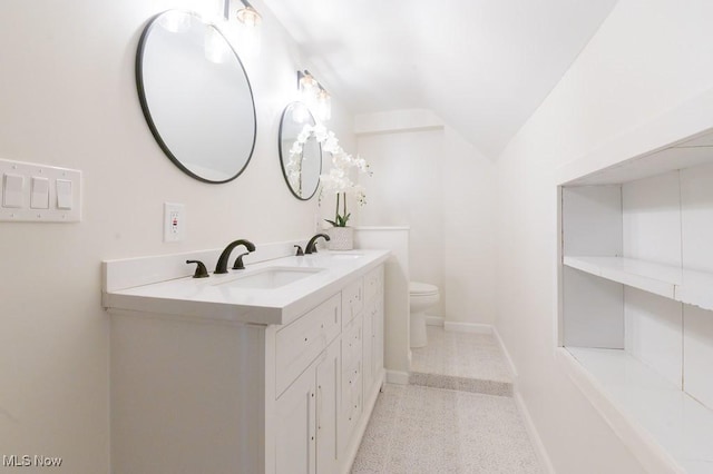 bathroom with vanity, toilet, and vaulted ceiling