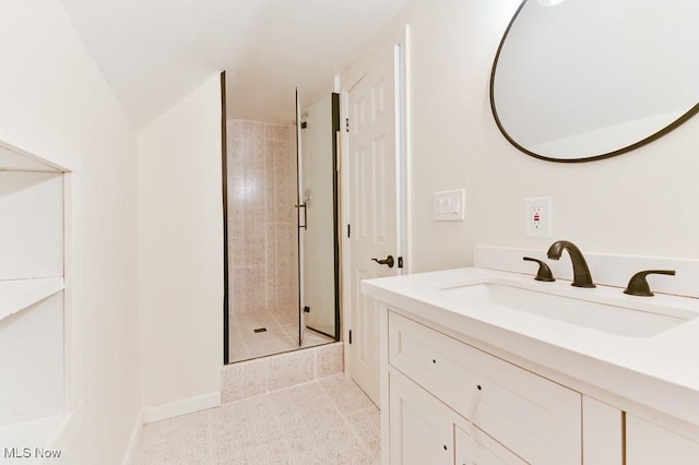 bathroom with tile patterned floors, vanity, and a shower with shower door