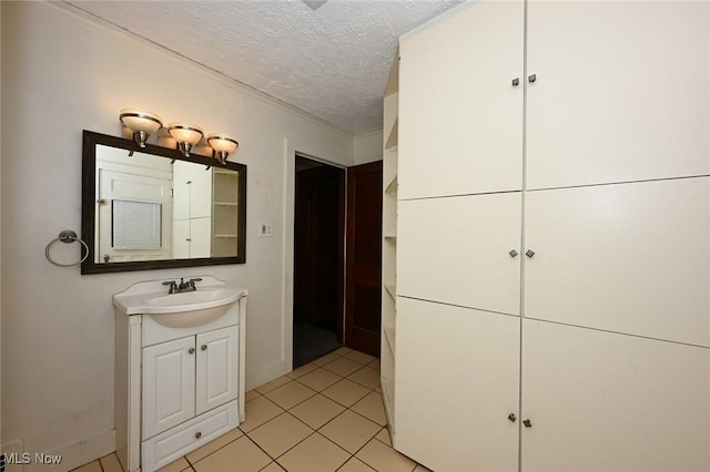 bathroom with tile patterned floors, vanity, and a textured ceiling