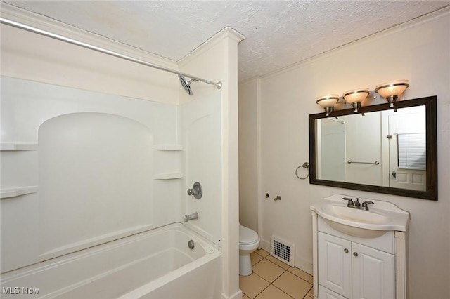 full bathroom featuring tile patterned floors, vanity, a textured ceiling, shower / washtub combination, and toilet