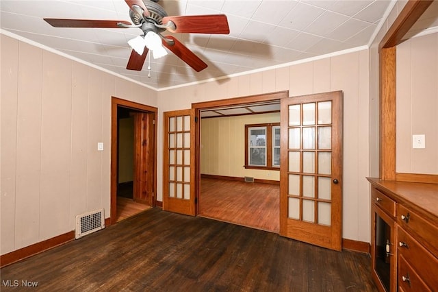 unfurnished room featuring french doors, dark hardwood / wood-style flooring, ceiling fan, and crown molding