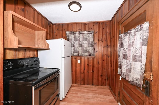 kitchen featuring black electric range, light wood-type flooring, wooden walls, and ornamental molding