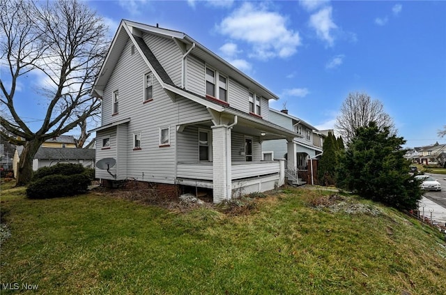 view of property exterior featuring covered porch and a yard