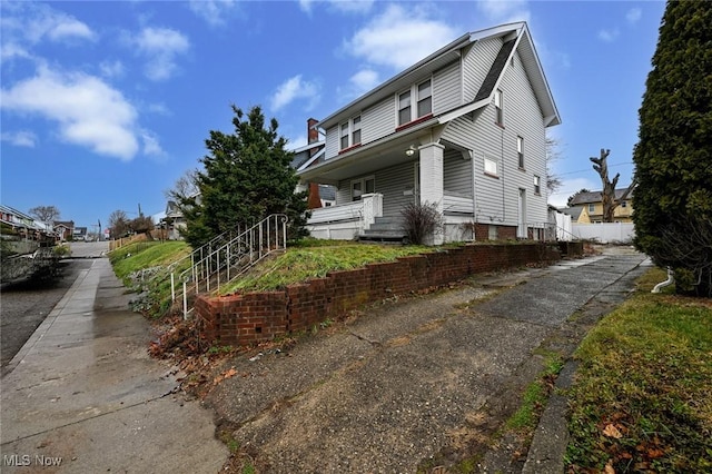 view of side of property with a porch